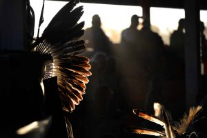 The evening sun hits a headdress at a powwow, June 2016. File photo by Philip McLachlan