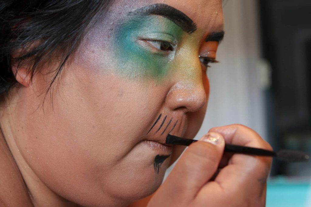 Madeline Terbasket, AKA Rez Daddy, prepares their makeup before a drag show at Brexit Pub in syilx homelands in Penticton, B.C., on June 16. Photo by Aaron Hemens