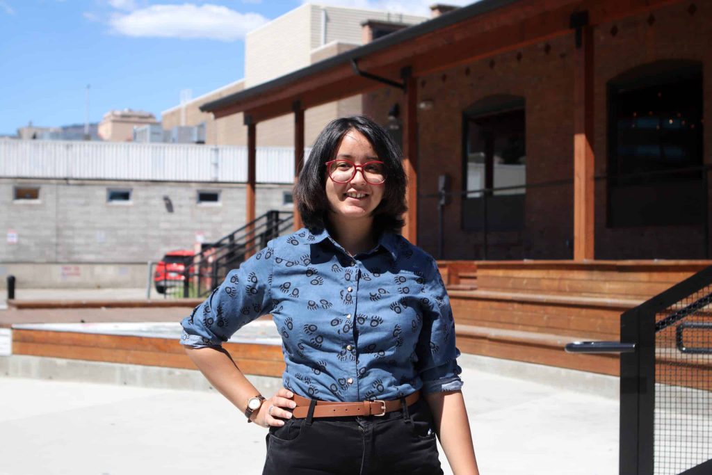 Alana Firedancer, the Indigenous programming assistant at Kelowna Museums, stands near the museum’s outdoor classroom at Laurel Square in kiʔláwnaʔ (Kelowna) in syilx homelands on July 26. Firedancer, who is Cree and Mètis, will help facilitate the museum’s “nsyilxcən for Everyone” outdoor language course. Photo by Aaron Hemens