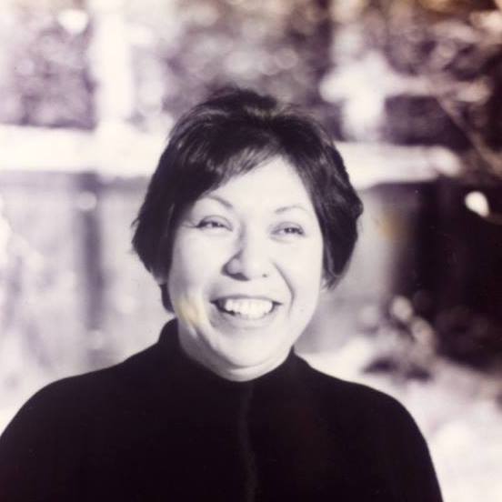 A black and white portrait of Mary Ann Assinabe smiling.