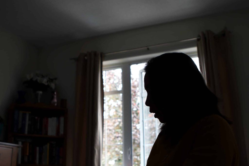 Mom silhouetted in her room. Photo by Aaron Hemens