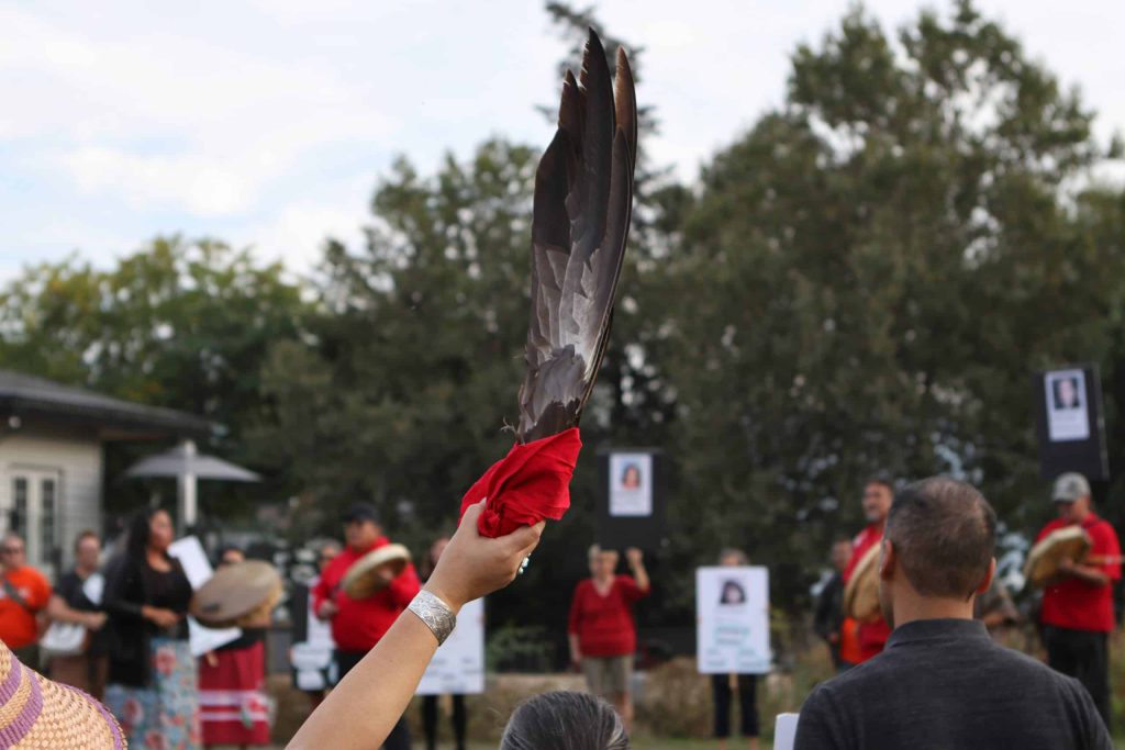 The 2022 Sisters in Spirit memorial march stops along a patch of grass off of Highway 97 in kiʔláwnaʔ (Kelowna) in syilx homelands on Oct. 4. Photo by Aaron Hemens