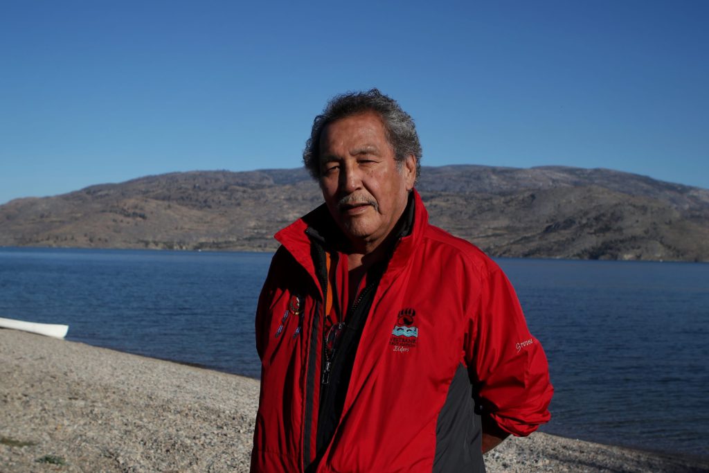 K̓ninm̓tm̓ taʔ n̓q̓ʷic̓tn̓s Wilfred “Grouse” Barnes, a syilx Elder and knowledge keeper from Westbank First Nation, stands at the shore of Okanagan Lake in syilx homelands on Sept. 25. Photo by Aaron Hemens