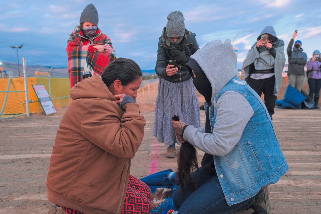 Secwépemc Matriarch Miranda Dick cut her hair during a ceremony to begin mourning for the land in October 2020. Her hair was cut by her sister who she trusted to care for her hair. (Photo: We, the Secwepemc Facebook)  