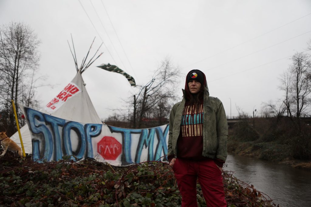 Khursten Bullock poses in front of a tipi that was assembled along the Trans Mountain Pipeline Expansion (TMX) project’s route in “Burnaby” on Jan. 21. Photo by Aaron Hemens