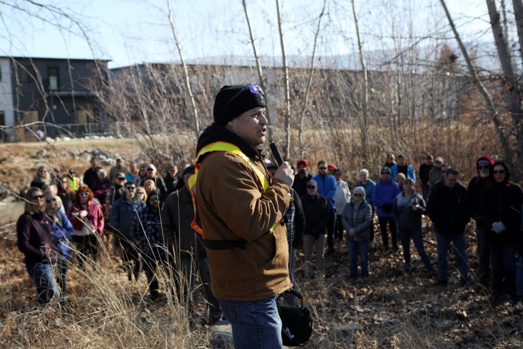Herb Alex of the Okanagan Nation Alliance’s kł cp̓əlk̓ stim̓ Hatchery speaks to a crowd further downstream from the nluxʷluxʷɬcwix (Trout Creek) restoration site in the district of “Summerland” in syilx homelands on March 22. Photo by Aaron Hemens