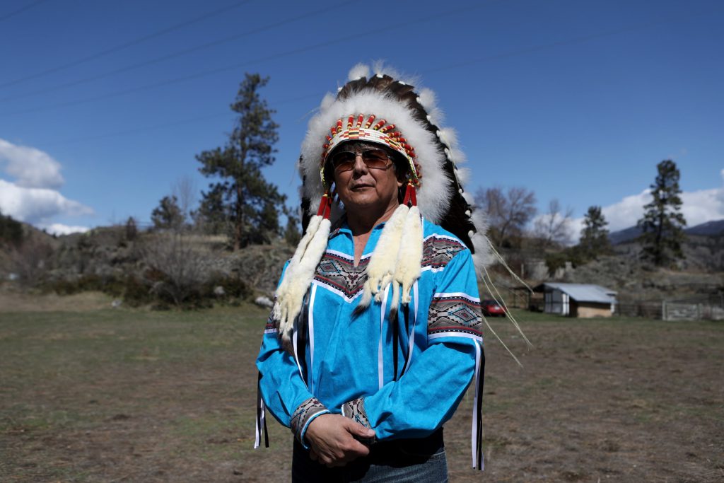 y̓ilmixʷm ki law na Chief Clarence Louie of Osoyoos Indian Band stands on a piece of original Osoyoos Indian Reserve land on April 14. One acre of land, which is home to a sacred salmon fishing site, was recently reacquired by the band in the sx̌ʷəx̌ʷnitkʷ (Little Falls) area in syilx homelands. Photo by Aaron Hemens