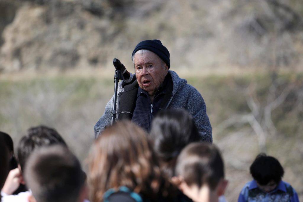 93-year-old Elder qʷʕayxnmitkʷ xʷəstalk̓iyaʔ Jane Stelkia, the oldest member of OIB, speaks in front of Youth during the Osoyoos Indian Band’s celebration on April 14 of a reclaimed one acre of their original reserve land. Photo by Aaron Hemens