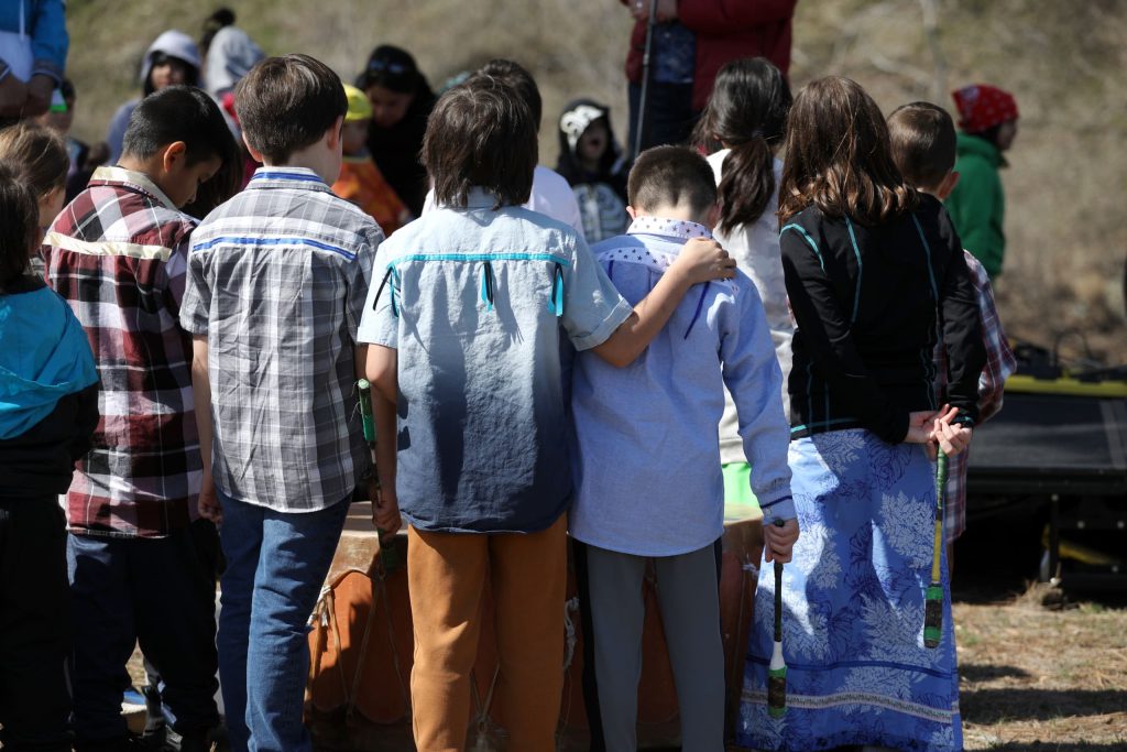 Students from Senpaq'cin School listen to a speaker during the Osoyoos Indian Band’s celebration on April 14 of a reclaimed one acre of their original reserve land. Photo by Aaron Hemens