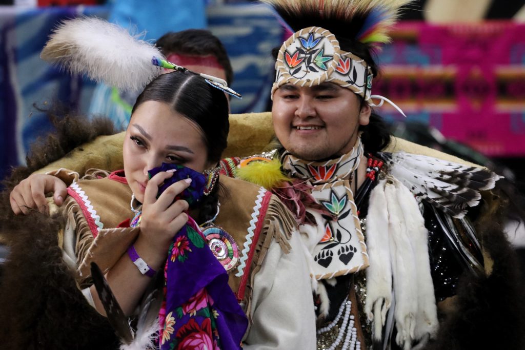 Nicole (Schellenberg) Kruger and Tyrone Kruger walk down the aisle following their wedding ceremony at the Four Seasons Cultural Society’s 2023 Between the Lakes Powwow at the South Okanagan Events Centre in snpink'tn (Penticton) in syilx homelands on June 24. Photo by Aaron Hemens