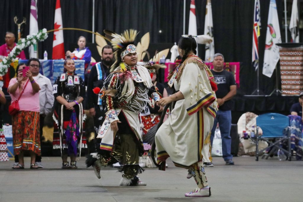 Tyrone Kruger and Nicole (Schellenberg) Kruger dance together following their wedding ceremony at the Four Seasons Cultural Society’s 2023 Between the Lakes Powwow at the South Okanagan Events Centre in snpink'tn (Penticton) in syilx homelands on June 24. Photo by Aaron Hemens