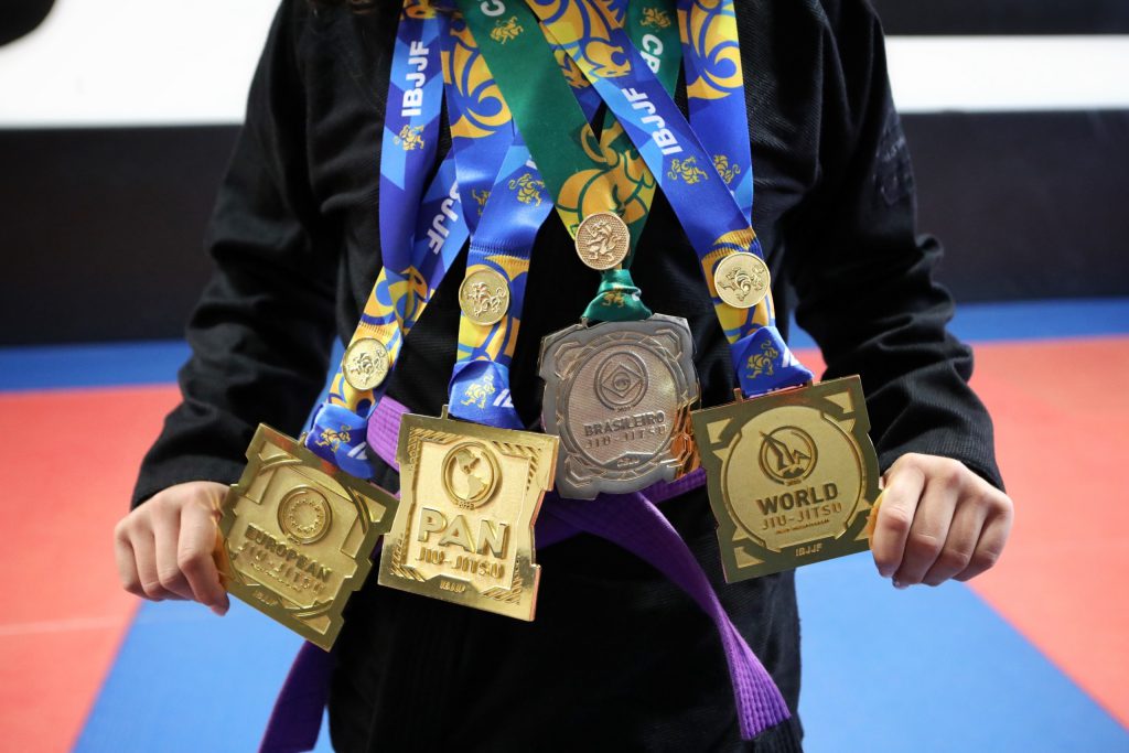 Lillian Marchand showcases her newly acquired purple belt and Grand Slam IBJJF achievement – a World championship, a Pan championship, a Brasileiro championship and European championship – that she earned this season. Photo by Aaron Hemens