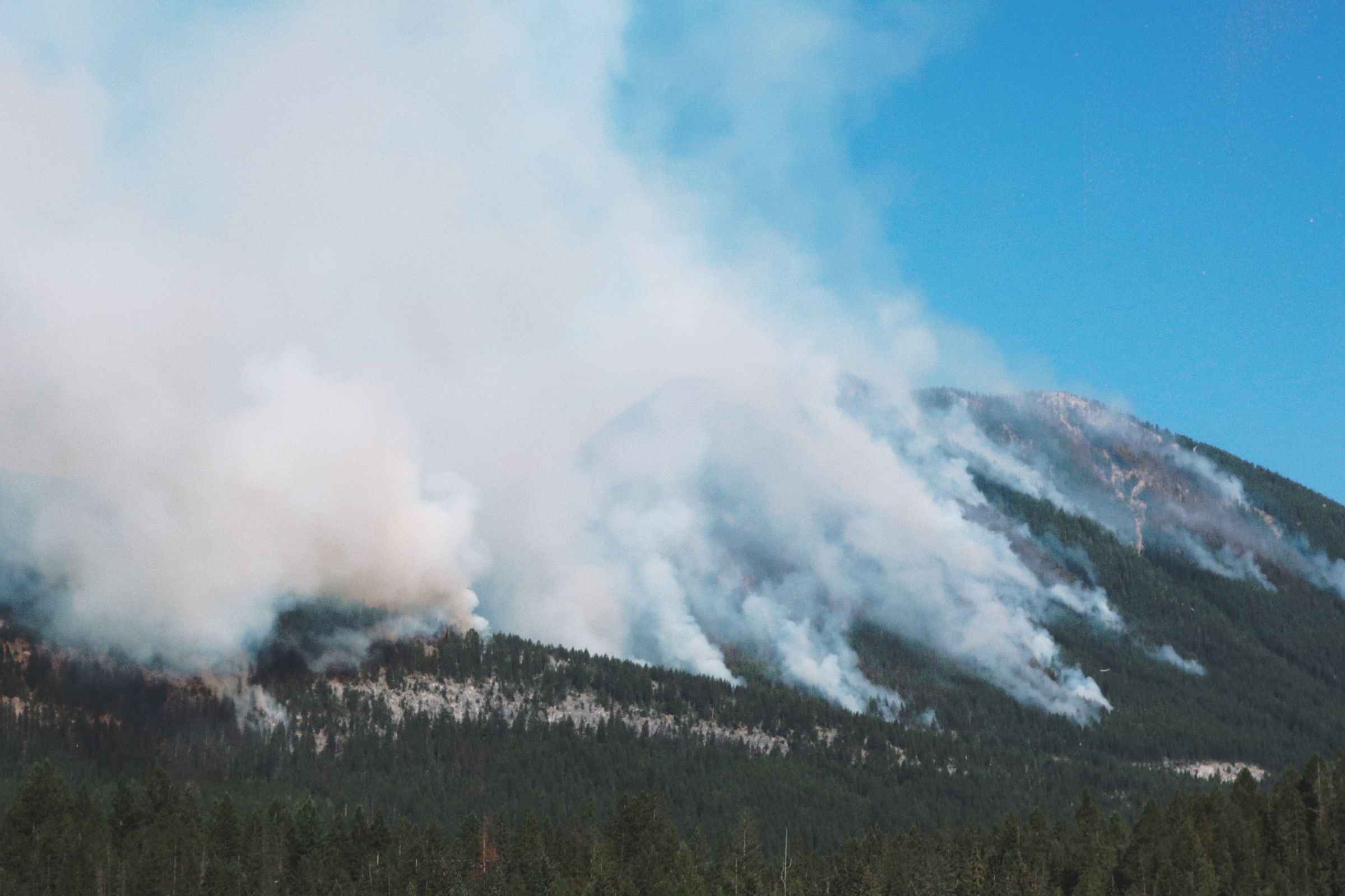 A wildfire sweeps through a mountainside in the Kootenay River watershed in August 2023. Photo by Mike Graeme