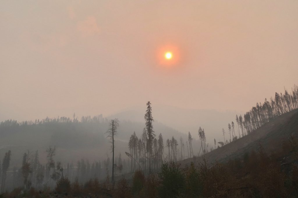 The sun rises over a megafire in the Purcell Mountain Range in August 2023. Photo by Mike Graeme