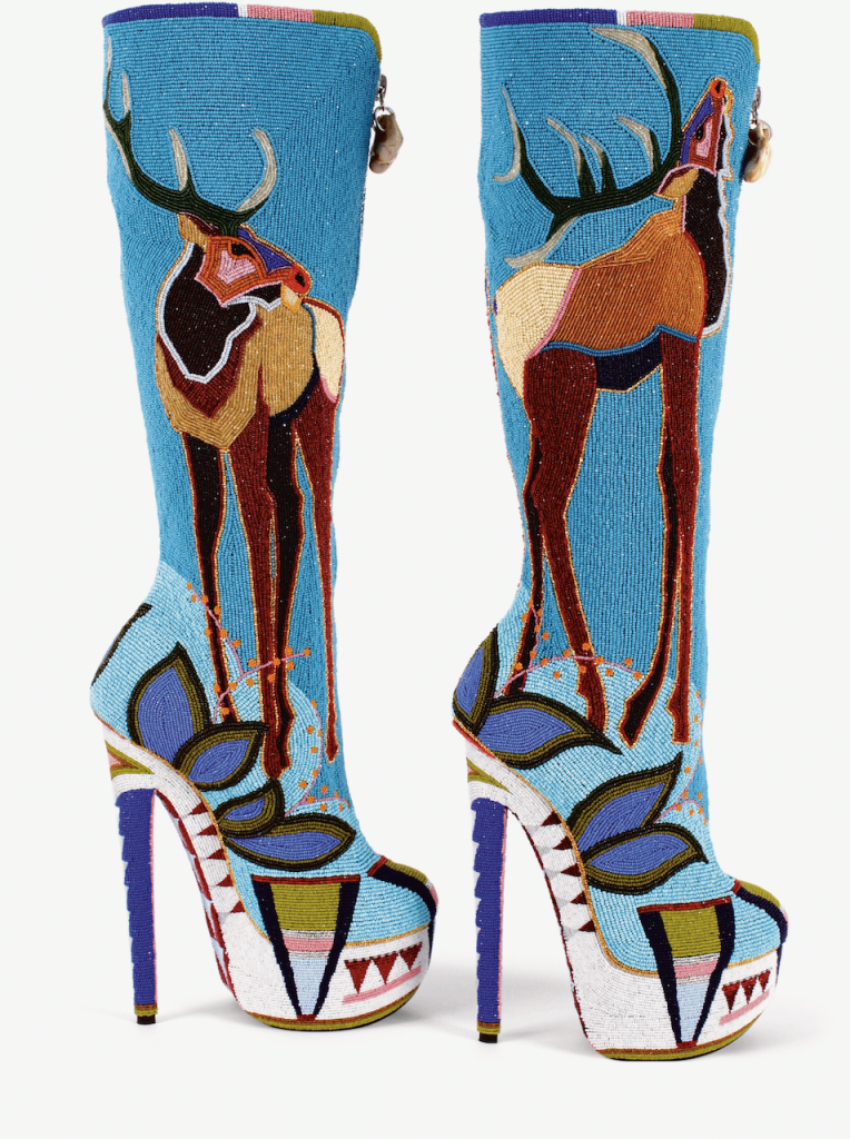 High heel boots covered in beadwork depicting an elk.