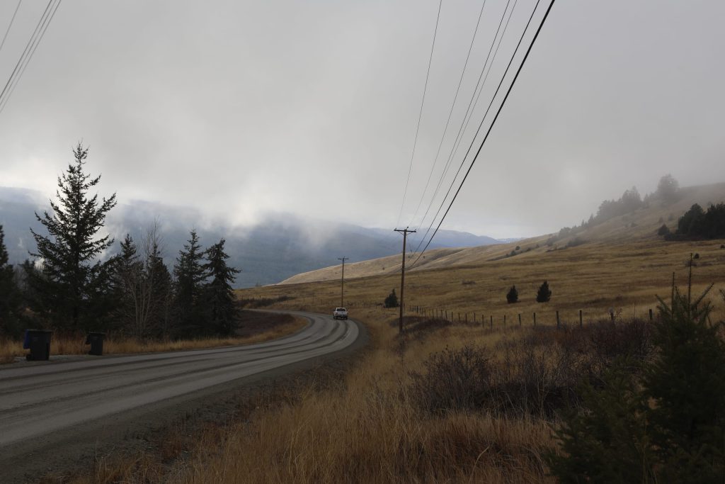 A vehicle moves down a roar at the Joe Rich community located outside of Kelowna, British Columbia, on Dec. 7, 2023. The community is in close proximity to a cherry orchard expansion site near a key wildlife corridor that ribbons around the Okanagan Mountain Provincial Park and Kalamalka Lake Provincial Park. Aaron Hemens/IndigiNews via AP