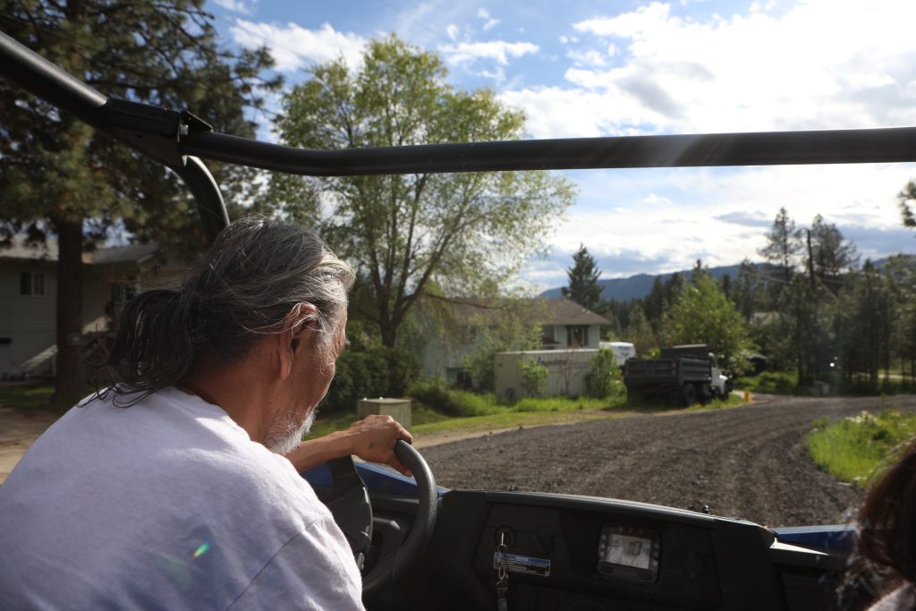 Neskonlith Indian Band members Miranda Dick and her father, Hereditary Chief Saw-ses, drive along Reserve number two roads in Secwepemcúl̓ecw that are covered with reclaimed asphalt pavement (RAP) on May 15. Photo by Aaron Hemens
