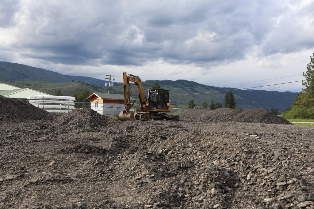 A stationed excavator at the site of the stockpile of RAP, stored nearby the community pow wow arbour and water treatment facility, on May 15. Photo by Aaron Hemens