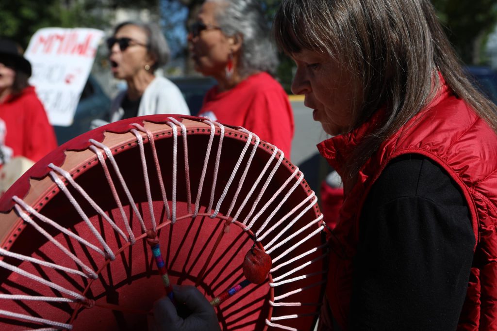 Drummers sing during a rally denouncing violence against women outside of Kamloops Courts in Secwepemcúl'ecw on June 20. Photo by Aaron Hemens