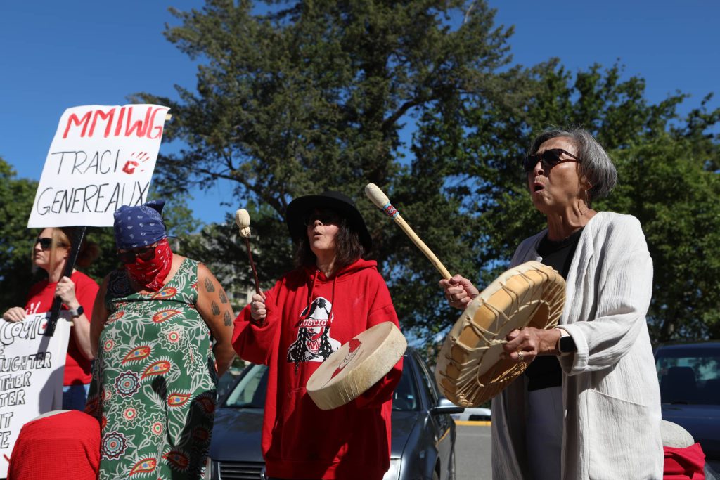 Drummers sing during a rally denouncing violence against women outside of Kamloops Courts in Secwepemcúl'ecw on June 20. Photo by Aaron Hemens