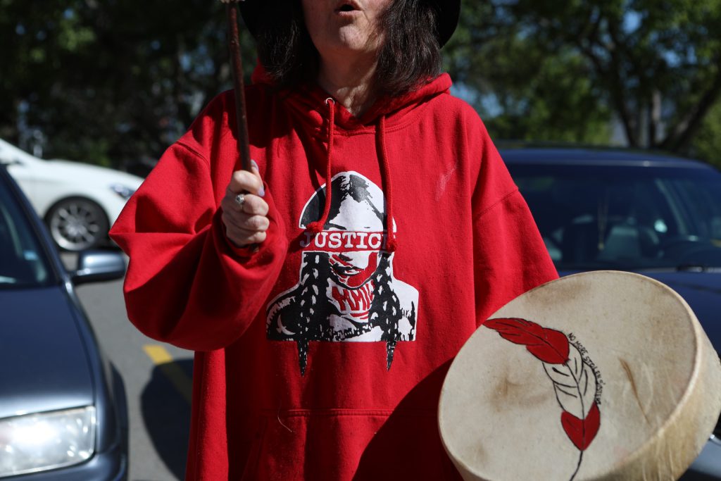 Janet Enoch plays her drum during a rally denouncing violence against women outside of the Kamloops court in Secwepemcúl'ecw on June 20. Photo by Aaron Hemens