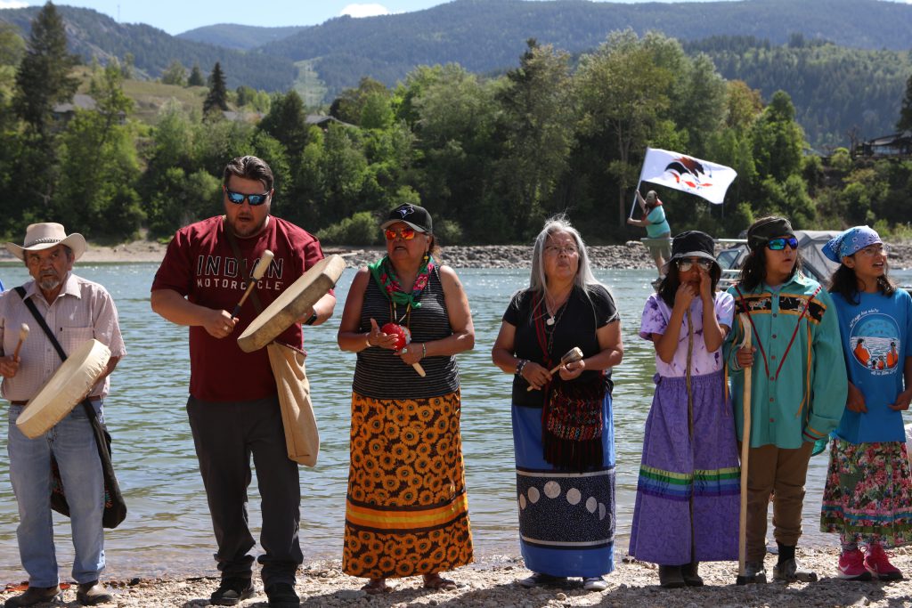 syilx Okanagan singers and drummers are pictured by the banks of nx̌ʷntk’ʷitkʷ (the Columbia River) in snɬuxwqnm (Castlegar) in syilx Okanagan territory during a ceremonial release hosted by the Okanagan Nation Alliance on May 13, 2024. Photo by Aaron Hemens