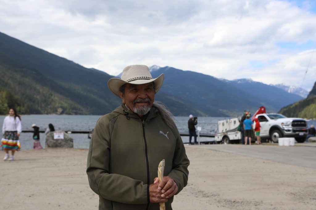 caylx Richard Armstrong, a syilx knowledge-keeper, stands by Slocan Lake in syilx Okanagan territory, prior to a ceremonial release hosted by the Okanagan Nation Alliance on May 13, 2024. Photo by Aaron Hemens