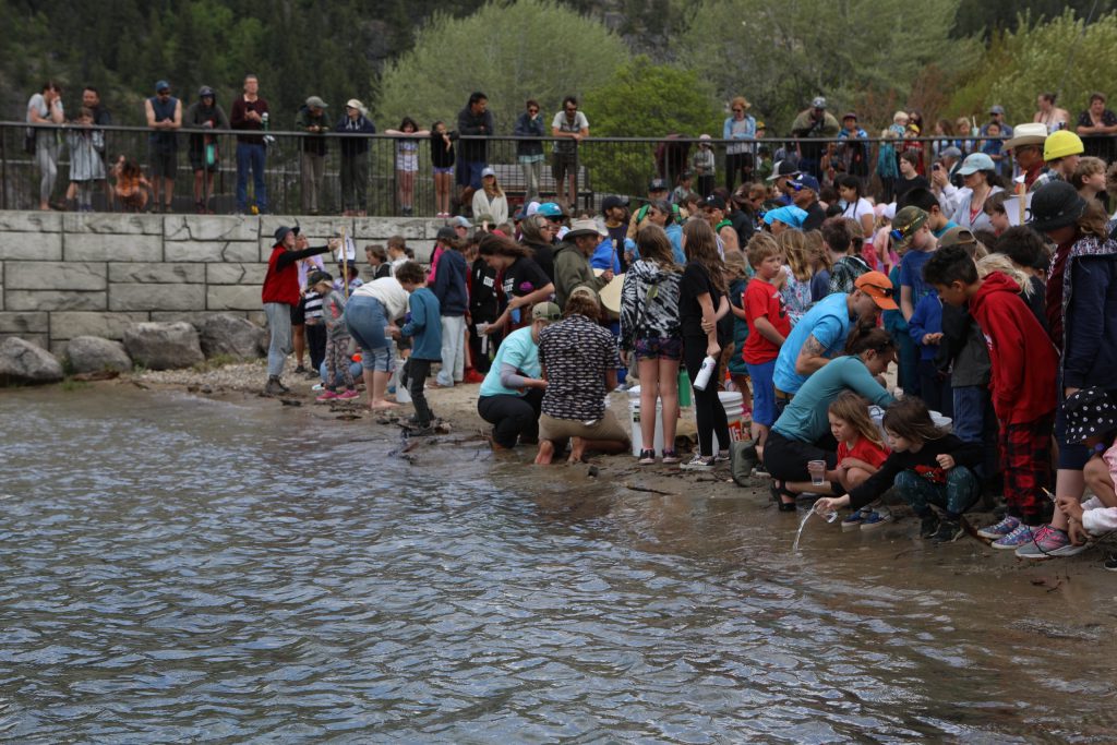 A salmon ceremonial release hosted by the Okanagan Nation Alliance gets underway at Slocan Lake in syilx Okanagan territory on May 13, 2024. Photo by Aaron Hemens