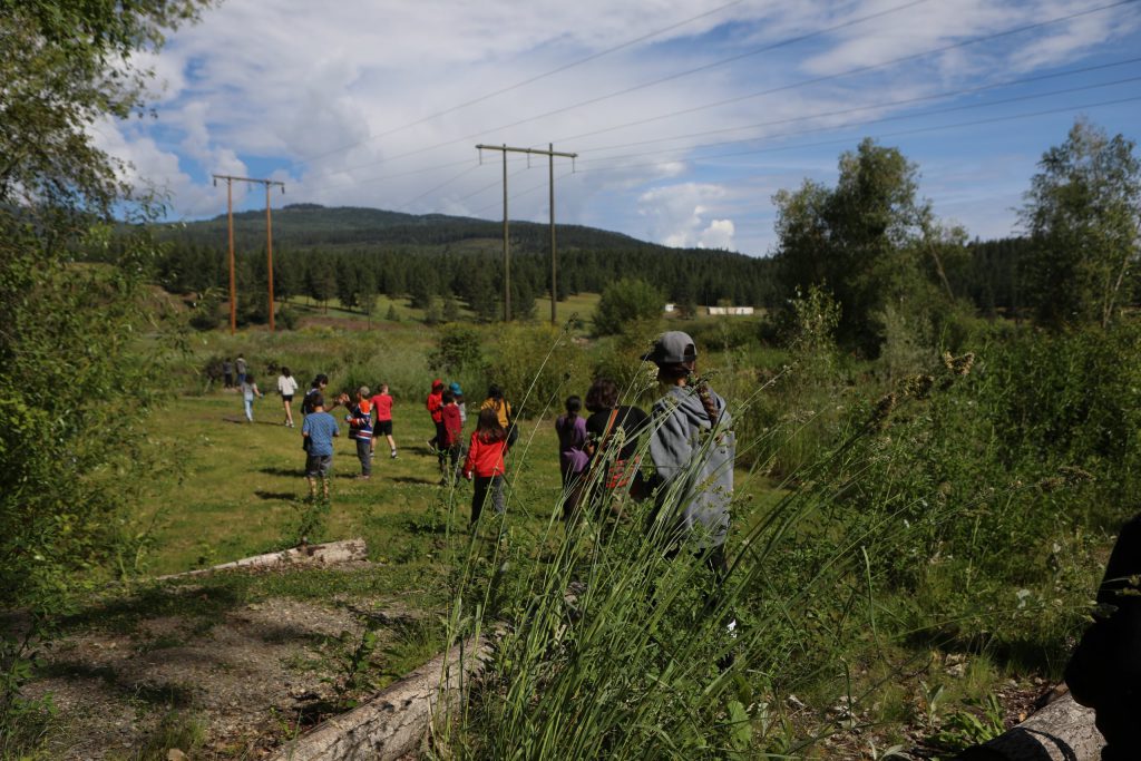Students from Okanagan Indian Band’s Cultural Immersion School gather before a salmon ceremonial release hosted by the Okanagan Nation Alliance into the Salmon River in syilx Okanagan territory on June 19, 2024. Photo by Aaron Hemens