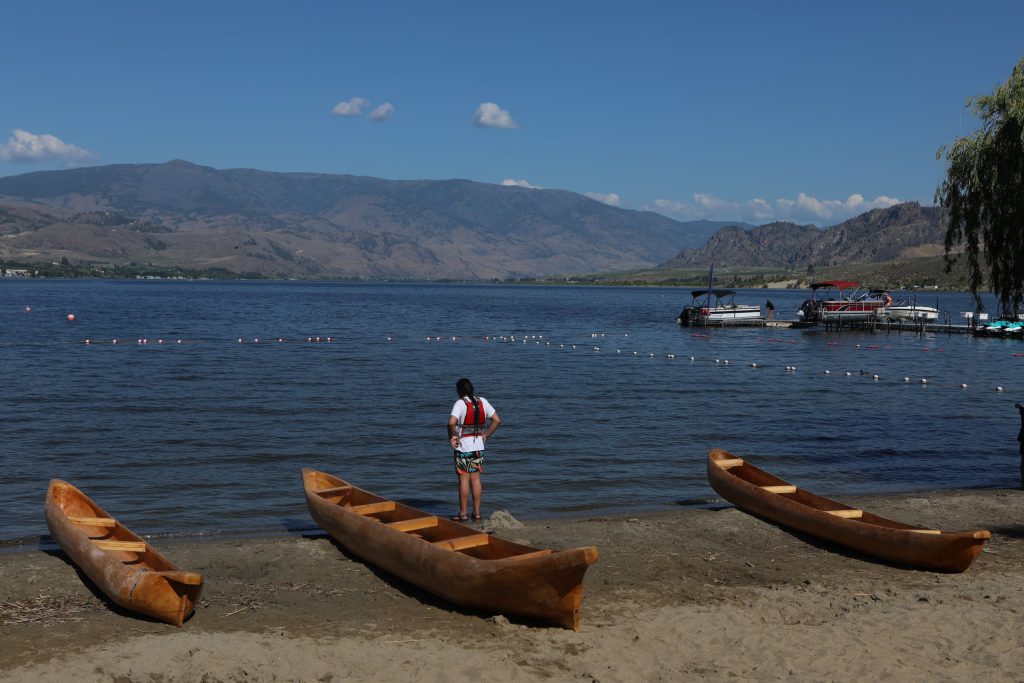Staring out into nk’mip (Osoyoos Lake) in sw̓iw̓s (Osoyoos), prior to the launch of the 2024 Sukʷnaqin canoe journey. Photo by Aaron Hemens
