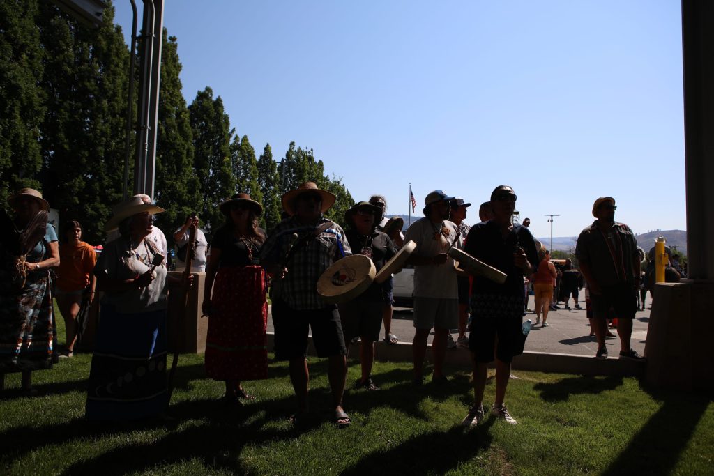 Singers and drummers welcome the group of horseback riders from “Canada” at the “Osoyoos-Oroville” border in syilx Okanagan homelands on July 20. Photo by Aaron Hemens