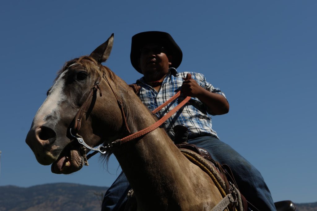 A rider manuevers their horse during the Unity Ride at the “Osoyoos-Oroville” border in syilx Okanagan homelands on July 20. Photo by Aaron Hemens