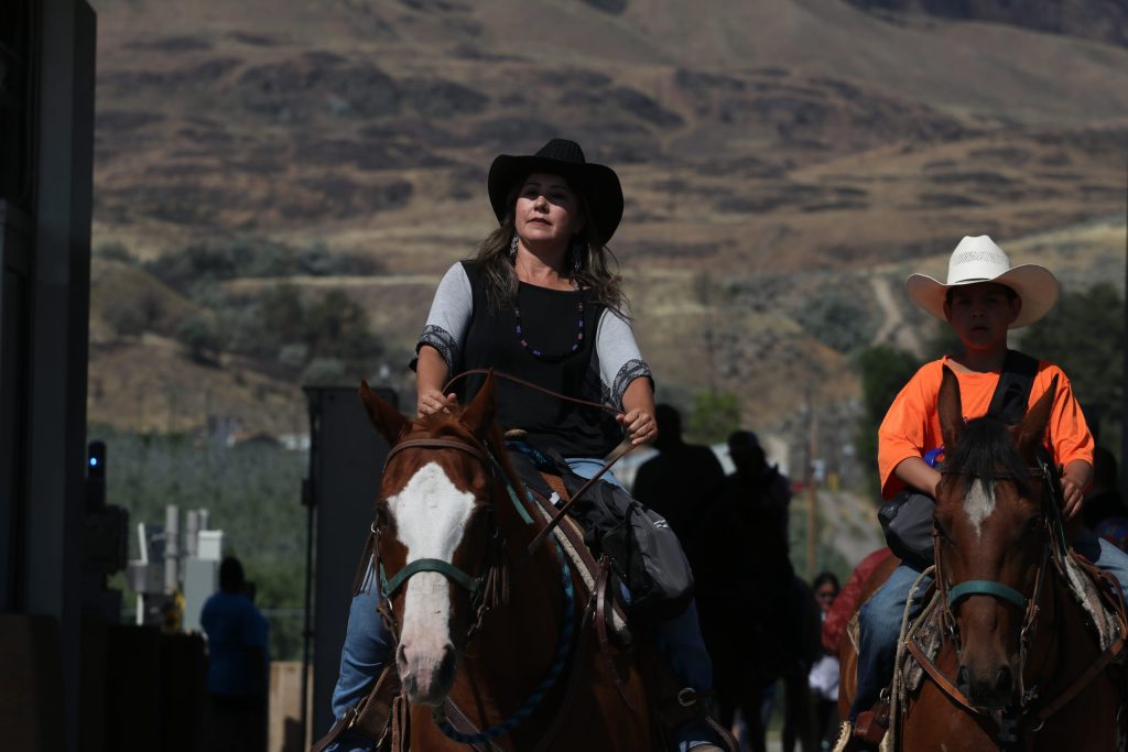 Riders cross into the “U.S.” from “Canada” via horseback at the “Osoyoos-Oroville” border in syilx Okanagan homelands on July 20. Photo by Aaron Hemens
