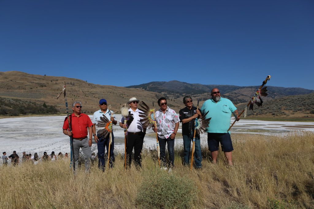 The chiefs of six syilx Okanagan member communities gather for a picture during the opening ceremony of the nation’s annual general assembly and Youth leadership summit at kłlilx’w (Spotted Lake) in sw̓iw̓s (Osoyoos) in syilx Okangan homelands on July 24. From left to right: Byron Louis, Okanagan Indian Band; Greg Gabriel, Penticton Indian Band; Dan Manuel, Upper Nicola Indian Band; Robert Louie, Westbank First Nation; Clarence Louie, Osoyoos Indian Band; and Keith Crow, Lower Similkameen Indian Band. Photo by Aaron Hemens