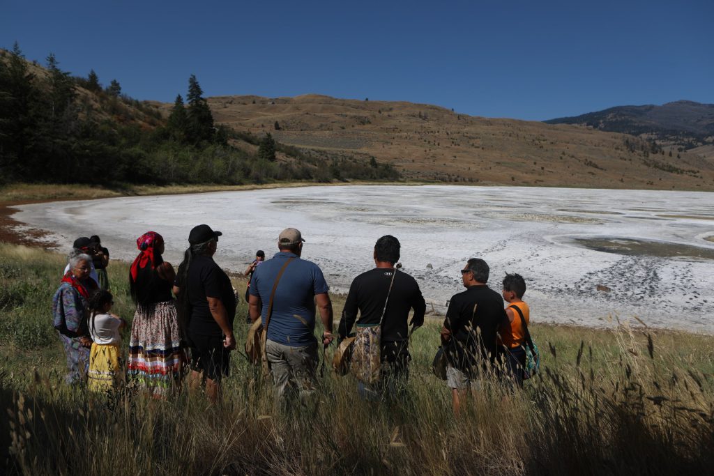 Singers and drummers stand near kłlilx’w (Spotted Lake) following the opening ceremony of the nation’s annual general assembly and Youth leadership summit in sw̓iw̓s (Osoyoos) in syilx Okangan homelands on July 24. Photo by Aaron Hemens
