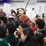 A child sits on the shoulders of a player participating in the 2025 All Native Basketball tournament during the opening ceremony of the 65th annual competition on Sunday. Photo by Aaron Hemens