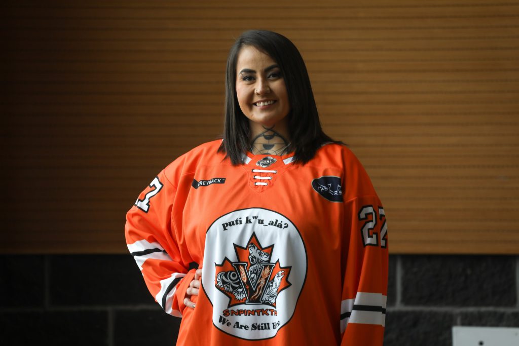 Wynona Paul, a syilx Okanagan multidisciplinary artist from the Penticton Indian Band, wears a Penticton Vees jersey that she designed for the team’s Indigenous Night on Jan. 31. The jerseys pay tribute to her culture and the resiliency of the syilx people, and were worn by the home team during an exhibition game. Photo by Aaron Hemens