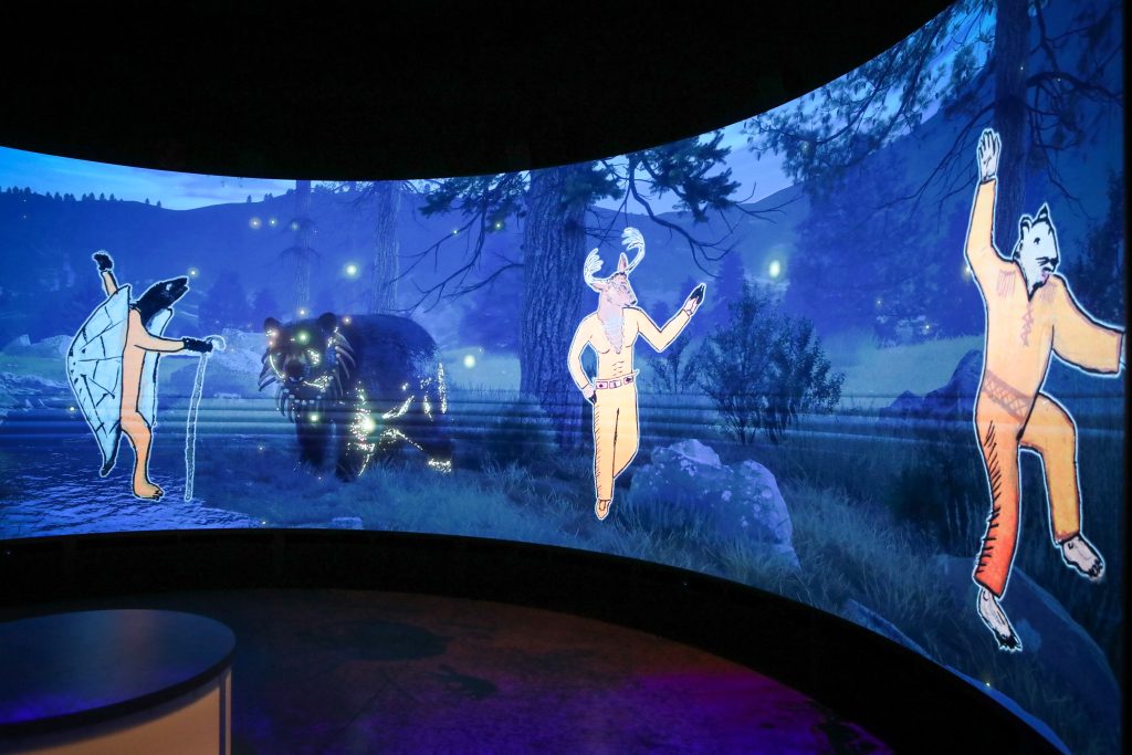 Life-size figures of Thi-tha-Kay Johnnie Stelkia's Animal People drawing are blown-up on-screen at the end of the Whispers of the Trickster film. Photo by Aaron Hemens