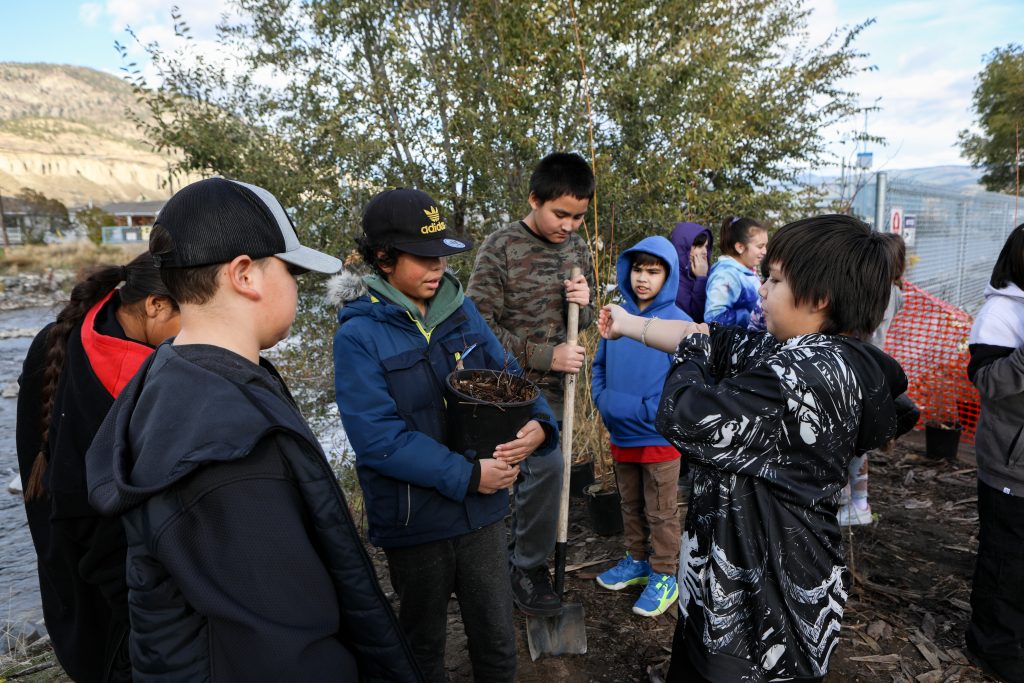 Elementary students from Outma Sqilx’w Cultural School prepare to plant trees and shrubs in the land surrounding the fish passage site at Okanagan Lake Dam in sn’pink’tn (Penticton) on Nov. 7. Photo by Aaron Hemens