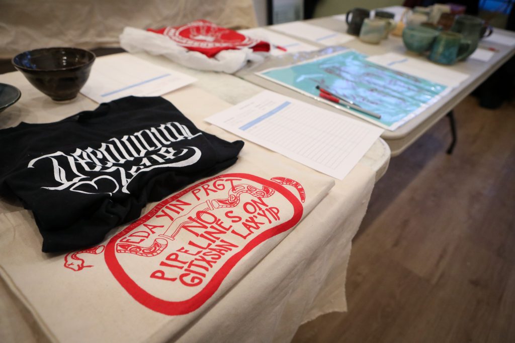Items in a silent auction fundraiser for anti-TMX land defenders in ‘Vancouver’ on Feb. 7 included pottery, apparel, artwork and getaway trips. Photo by Aaron Hemens