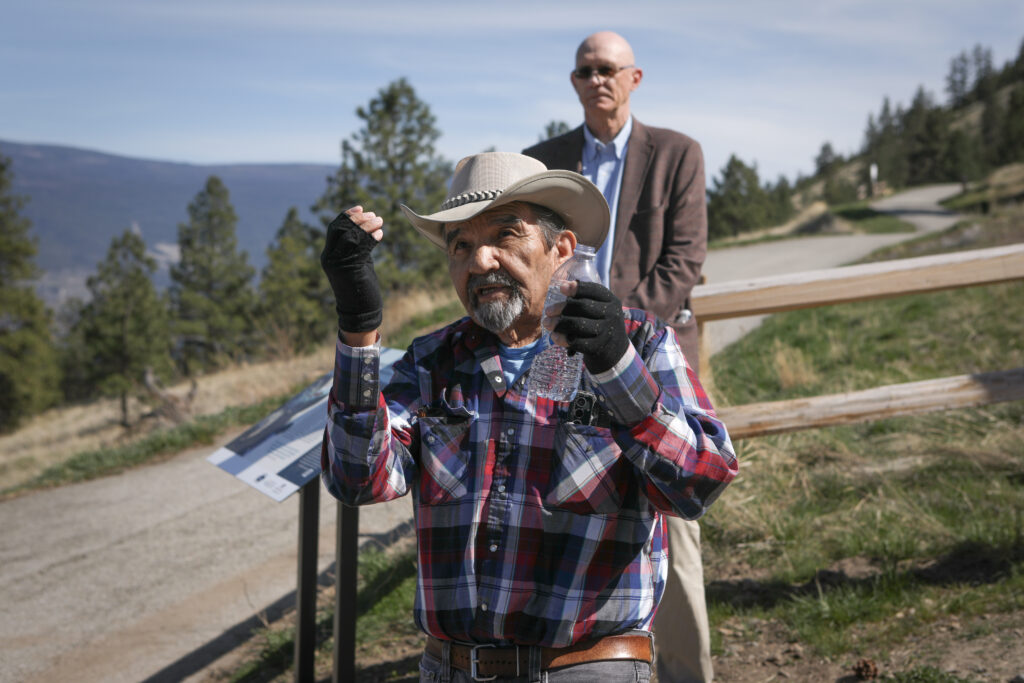 Elder and knowledge keeper caylx (Richard Armstrong) shares syilx oral stories — captikʷł — about ackɬt’pus (Giant’s Head Mountain). Behind him stands District of Summerland Mayor Doug Holmes, at an April 10 event to unveil four interpretive signs about syilx history and culture. Photo by Aaron Hemens