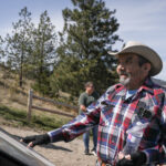 caylx (Richard Armstrong), a syilx Elder and knowledge keeper, looks up towards ackɬt’pus (Giant’s Head Mountain) after examining one of four new interpretive signs on April 10. The signs detail syilx history and culture along the trails of the mountain. Photo by Aaron Hemens