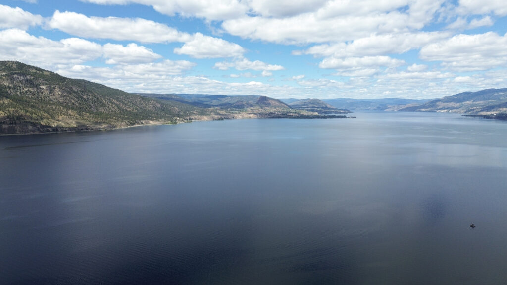 An aerial view of kɬúsx̌nítkʷ (Okanagan Lake) in syilx territory, from May 14, 2026. Photo by Aaron Hemens