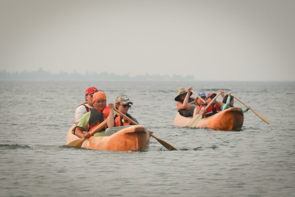 Dugout canoes with the syilx Nation’s 2026 Unity Trek Commemorative Paddle near the shores of Penticton on July 30. The canoes were carved by Herman Edward, who participated in the original journey in 2001. Photo by Aaron Hemens