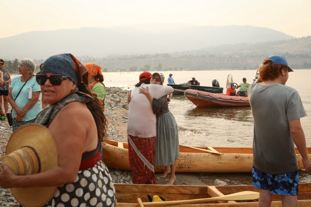 Community members celebrate after three dugout canoes arrive in Penticton on July 30, concluding a six-day canoe paddle across Okanagan Lake. The canoes were carved by Herman Edward, who participated in the original journey in 2001. Photo by Aaron Hemens
